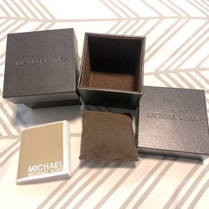 Two Michael Kors watch boxes.